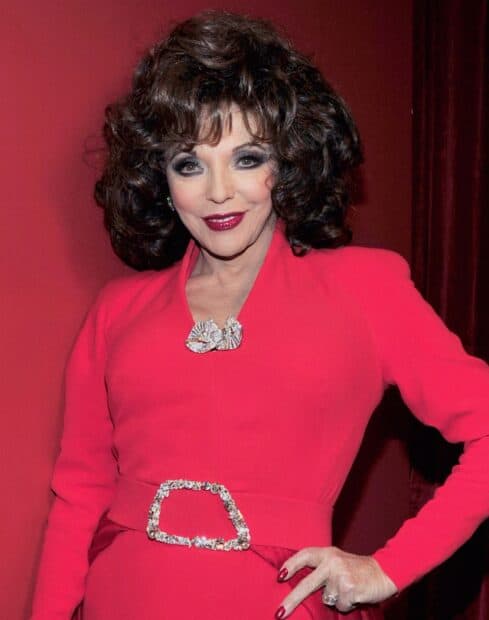 Joan Collins wears a striking red outfit with detailed accessories and styled hair, HD Desktop Wallpaper