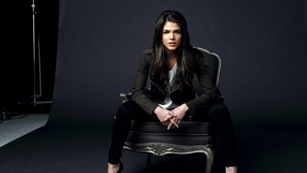 Marie Avgeropoulos sits confidently in a chair wearing dark clothing, HD Desktop Wallpaper