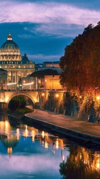The Rome skyline at twilight is beautifully reflected in the river under a cloudy sky, 2K Mobile Wallpaper