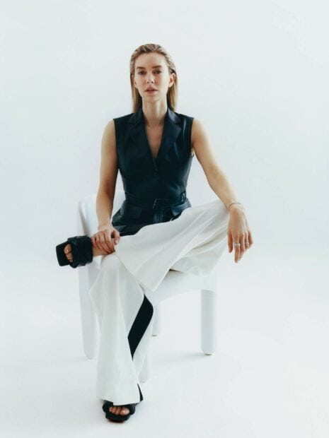 Vanessa Kirby wallpapers showing her seated with stylish expression, 2K Phone Wallpaper