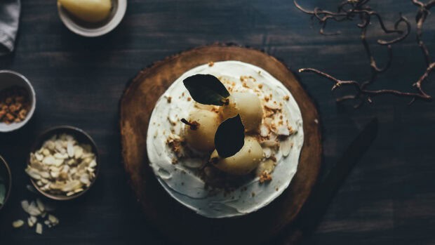 A tasty dish with pears and cream decorated with leaves on a wooden board, 4K Desktop Wallpaper