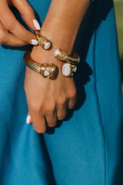 A close up of elegant gold bracelets with pearls on a wrist, 2K Mobile Wallpaper