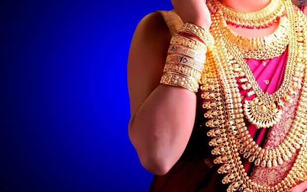 A woman wearing elegant gold jewelry with intricate designs on traditional clothing, HD Mobile Wallpaper