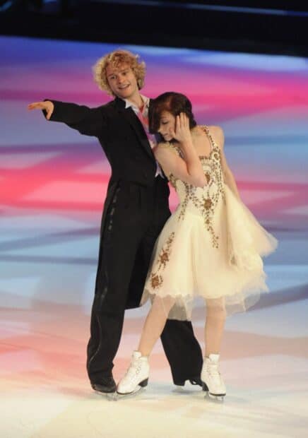 A couple performs an elegant ice dancing routine on a vibrant ice rink, HD Mobile Wallpaper