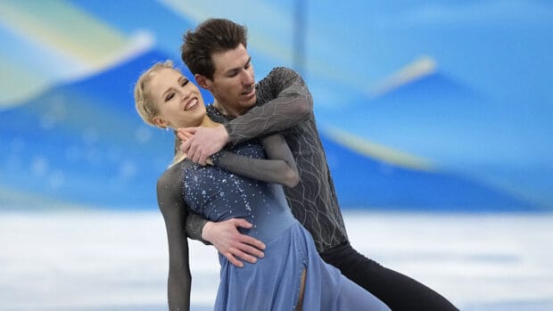 A pair performs a graceful ice dancing routine in blue costumes, 4K Desktop Wallpaper