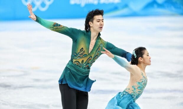 A male and female skater perform a graceful ice dancing routine on the rink, HD Desktop Wallpaper