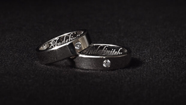 Two elegant wedding rings with diamonds on dark surface, HD Desktop Wallpaper