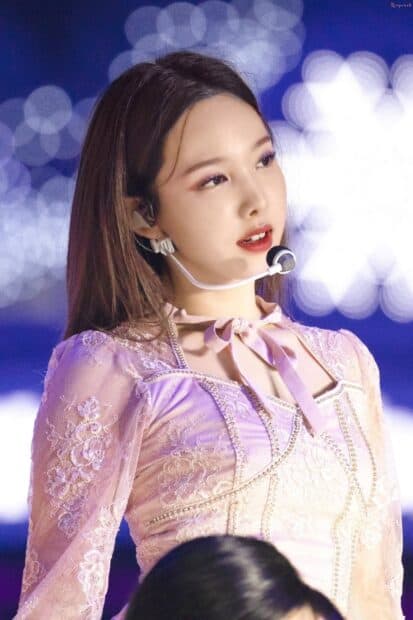 Nayeon Wallpapers shows her wearing a delicate lavender outfit during a stage performance, HD Mobile Wallpaper