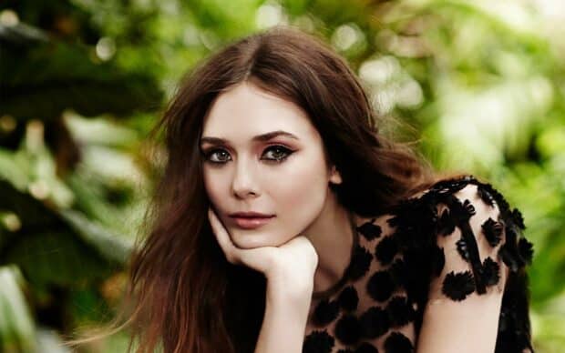 A close up of Elizabeth Olsen with a thoughtful expression in a natural background, HD Desktop Wallpaper