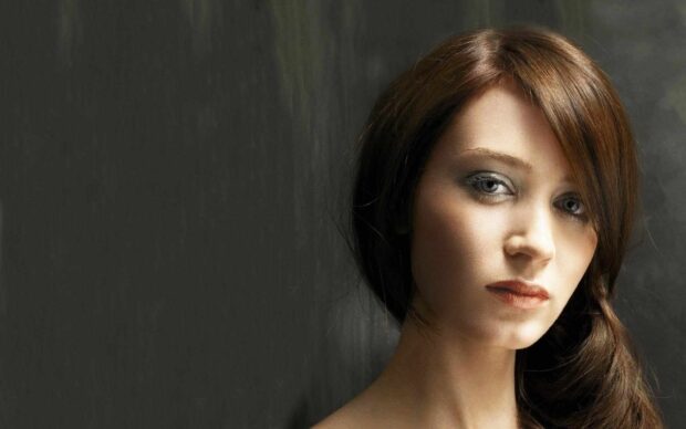 A close up of Emily Blunt with soft lighting and a dark background, HD Desktop Wallpaper