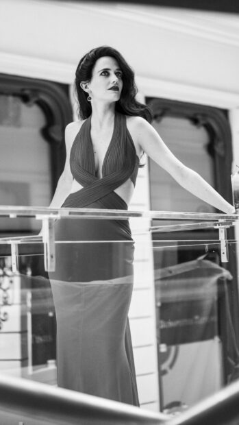 Eva Green wearing a stylish dress and standing near a glass railing, HD Mobile Wallpaper