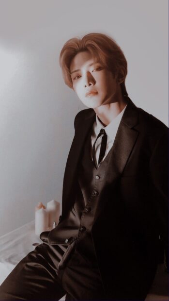 Kang Yeo Sang is wearing a formal black suit sitting calmly against a light background, HD Phone Wallpaper