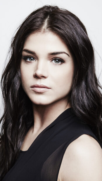A close up portrait shows Marie Avgeropoulos with striking blue eyes and dark hair, 4K Phone Wallpaper