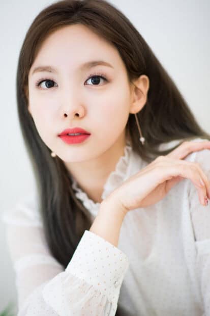 A close up portrait of Nayeon shows her delicate features and soft expression, 2K Mobile Wallpaper