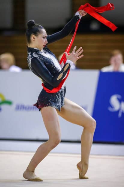 A rhythmic gymnast performs a ribbon routine with focus and grace, HD Mobile Wallpaper