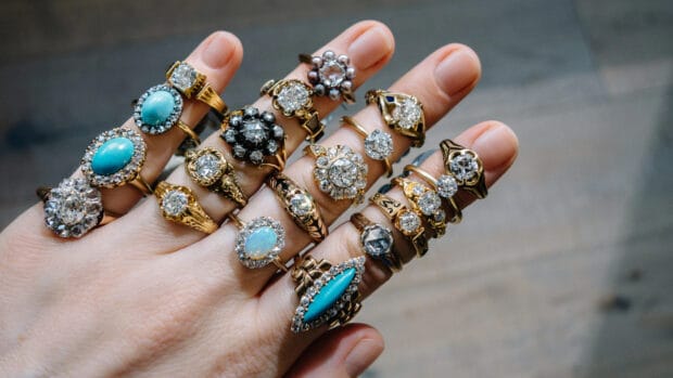 A hand adorned with intricate rings featuring diamonds and turquoise highlights jewelry wallpapers, HD Desktop Wallpaper