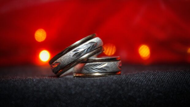 Two silver wedding rings with leaf engravings on black fabric, HD Mobile Wallpaper
