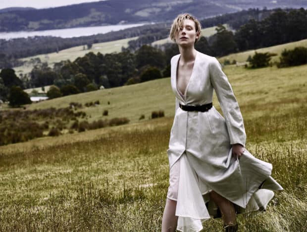 A woman in an elegant flowing dress walks on a grassy hill landscape, HD Desktop Wallpaper