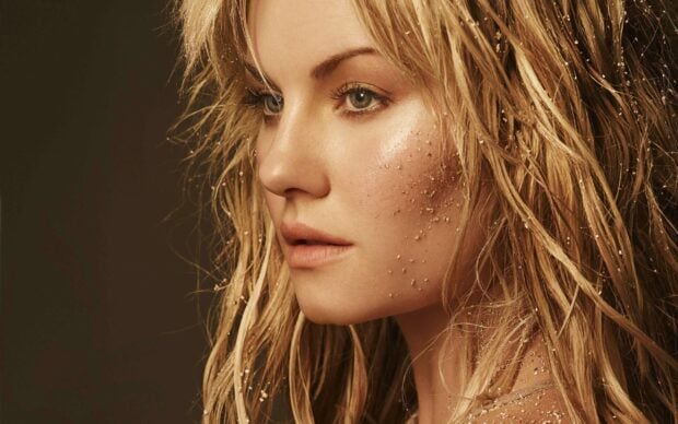 A close up portrait of Elisha Cuthbert with golden glitter on her face and hair, 2K Desktop Wallpaper