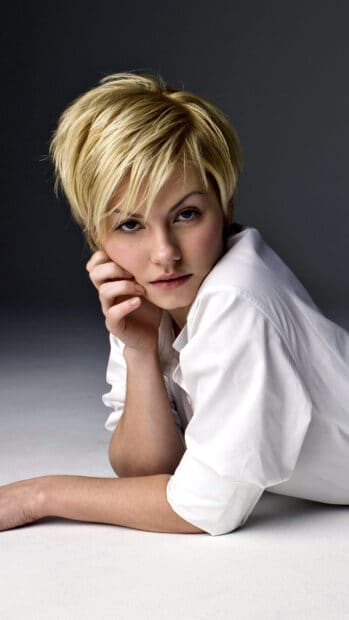 A portrait of Elisha Cuthbert with short blonde hair and a white shirt lying on the floor, 4K Mobile Wallpaper