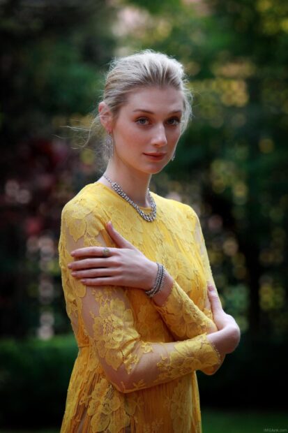 Elizabeth Debicki wears a yellow lace dress with silver jewelry in a garden setting, HD Mobile Wallpaper