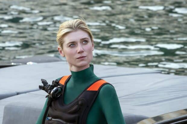 Elizabeth Debicki is standing near water wearing a green wetsuit with orange straps, 2K Desktop Wallpaper