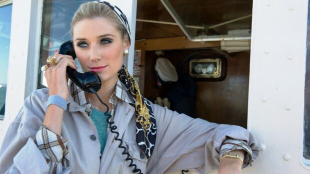 Elizabeth Debicki talks on a vintage black phone while wearing a patterned scarf, HD Desktop Wallpaper