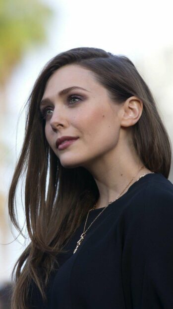 Elizabeth Olsen with long hair and confident expression in a dark outfit, HD Mobile Wallpaper