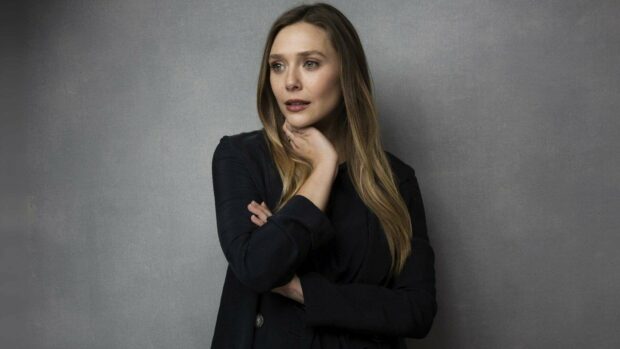 Elizabeth Olsen is posing thoughtfully against a gray background, HD Desktop Wallpaper