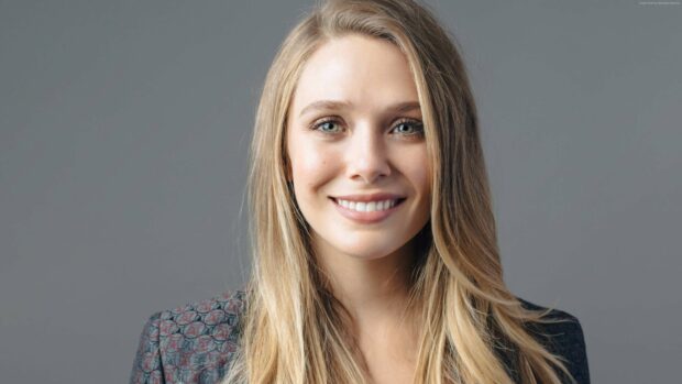 Elizabeth Olsen smiles warmly in a patterned blazer with long blonde hair, 4K Desktop Wallpaper
