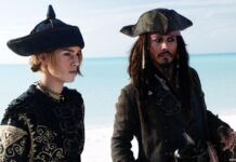 Elizabeth Swann and Jack Sparrow stand near the ocean in detailed pirate attire, 2K Desktop Wallpaper