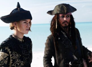 Elizabeth Swann and Jack Sparrow stand near the ocean in detailed pirate attire, 2K Desktop Wallpaper