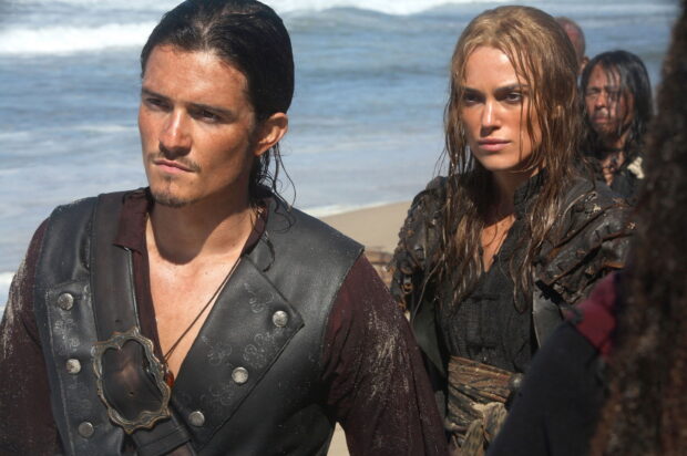 Elizabeth Swann and Will Turner stand on a beach in a Pirates Of The Caribbean moment, HD Desktop Wallpaper