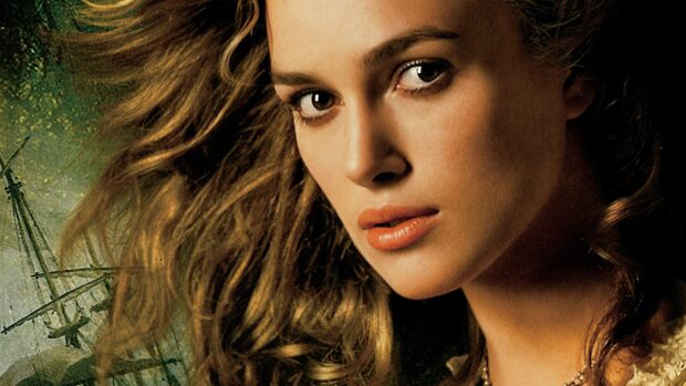 A close up of Elizabeth Swann from Pirates of the Caribbean with a ship in the background, HD Desktop Wallpaper