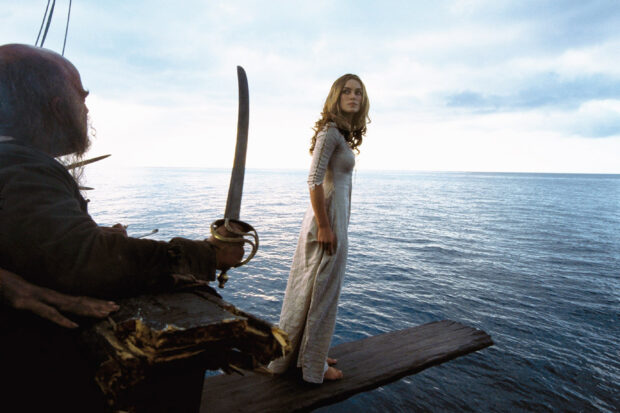 Elizabeth Swann stands barefoot on a plank extending over the ocean with a pirate holding a sword nearby, 2K Desktop Wallpaper