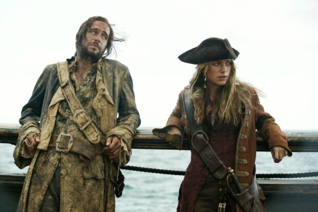 Elizabeth Swann stands on a ship deck beside a worn pirate, 2K Desktop Wallpaper