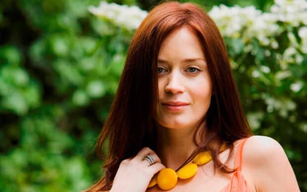 A close up of Emily Blunt wearing a yellow necklace outdoors with green foliage behind her, HD Desktop Wallpaper