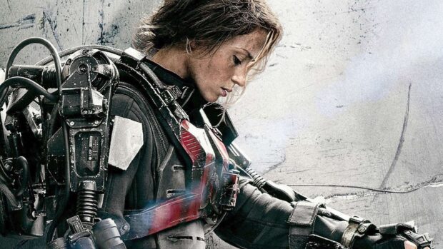 Emily Blunt is dressed in a futuristic armor suit looking down thoughtfully, HD Desktop Wallpaper