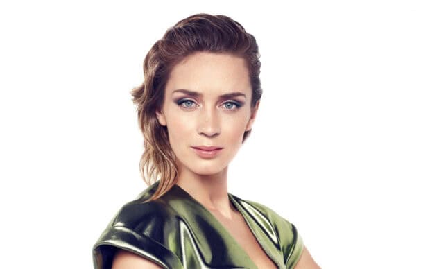 Emily Blunt looks confidently at the camera in a shiny green outfit, HD Desktop Wallpaper