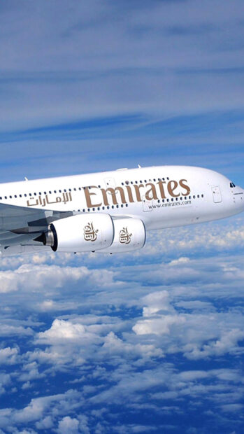 An Emirates Airbus A380 is flying above the clouds in a clear blue sky, HD Phone Wallpaper