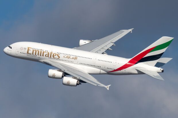 An Emirates Airbus A380 is flying through a clear sky during the day, HD Desktop Wallpaper