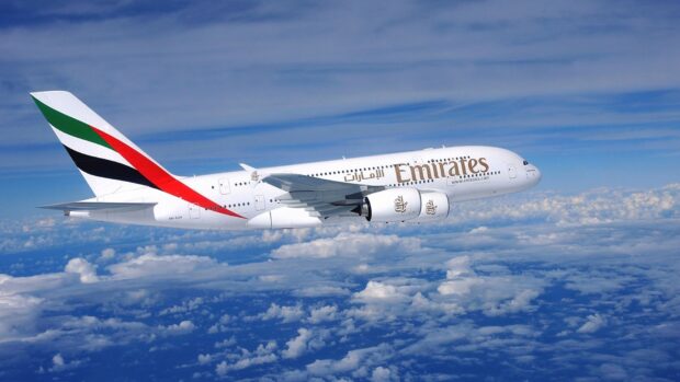 A large Emirates aircraft is flying high above the clouds in a clear blue sky depicting Aircraft Wallpapers, HD Desktop Wallpaper