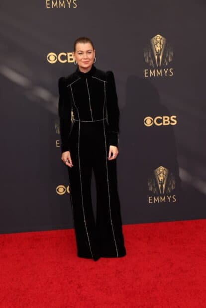 A woman wearing a black velvet outfit stands on the Emmy Awards red carpet with CBS logos in the background, HD Mobile Wallpaper