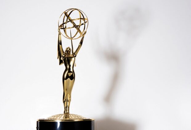 A close up of an Emmy Awards trophy casting a shadow on a white background, HD Desktop Wallpaper