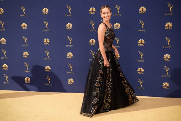 A woman in a floral black gown smiles at the Emmy Awards event, HD Desktop Wallpaper