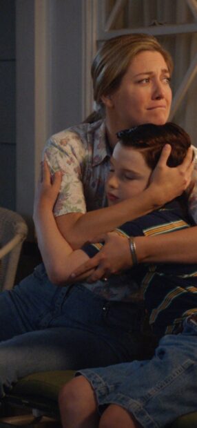 A woman embraces a young boy with concern and care in Young Sheldon Tv Series, HD Mobile Wallpaper