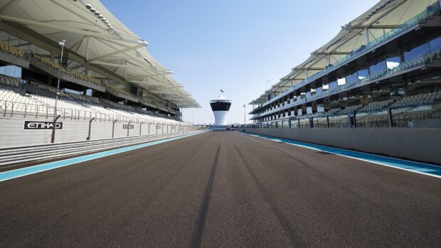 A clear view of a race track with grandstands and a control tower in the distance, HD Desktop Wallpaper