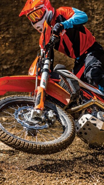 A rider on an enduro motorbike navigates through dirt terrain with precision, 2K Mobile Wallpaper