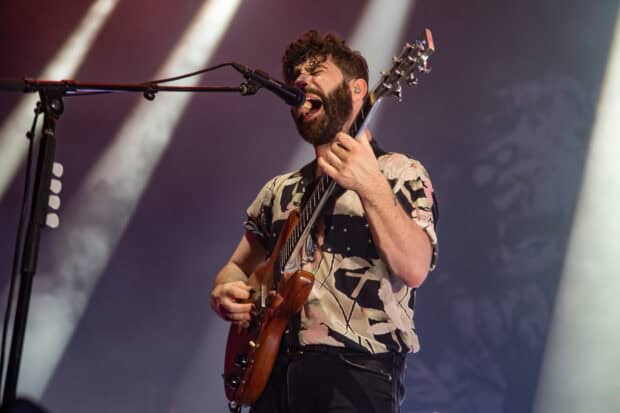 A Foals band member passionately sings and plays guitar on stage, HD Desktop Wallpaper