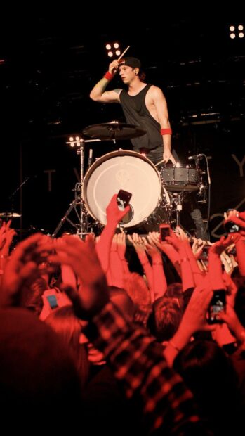 Josh Dun engages the crowd with an intense drum solo during a live show, HD Phone Wallpaper
